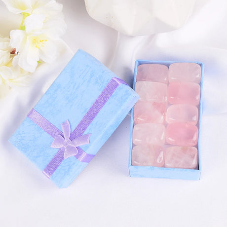 Pink stones in a light blue box with a ribbon on a white background
