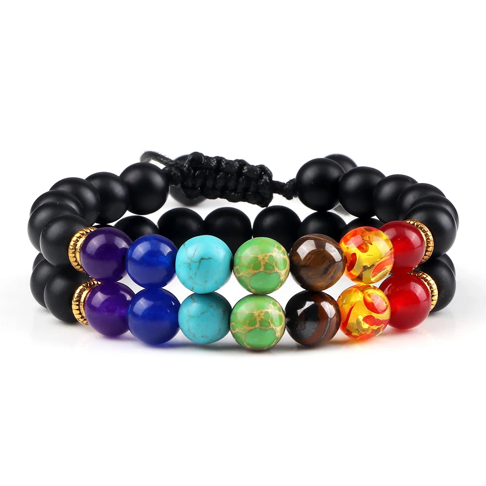 Stack of colorful beaded bracelets on a white background