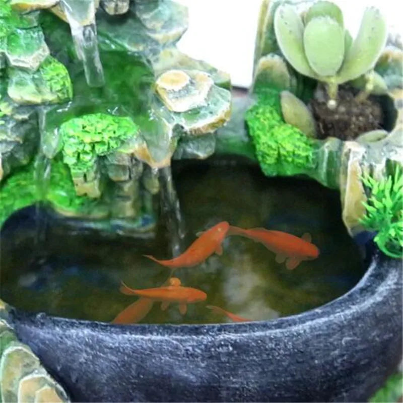 Feng Shui water fountain with goldfish and greenery