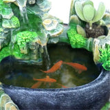 Feng Shui water fountain with goldfish and greenery