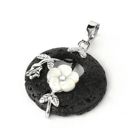 Black stone pendant with white floral design on a white background