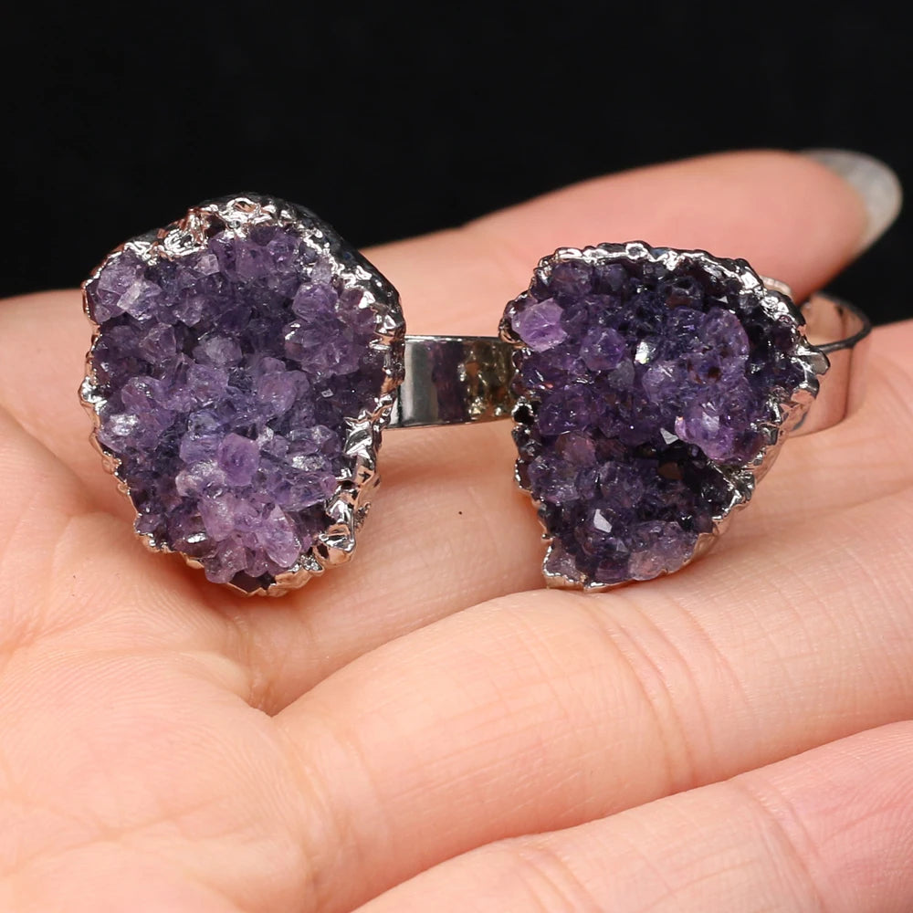Purple geode cufflinks on a hand with a black background