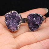Purple geode cufflinks on a hand with a black background