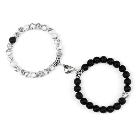 Two bracelets, one with black beads and silver charms, the other with silver beads and black beads, on a white background.