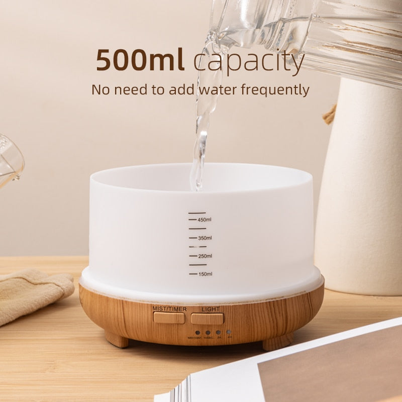 White and wooden diffuser with water being poured into it, labeled for 500ml capacity.