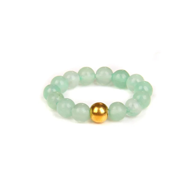 Beaded bracelet with a gold bead on a white background