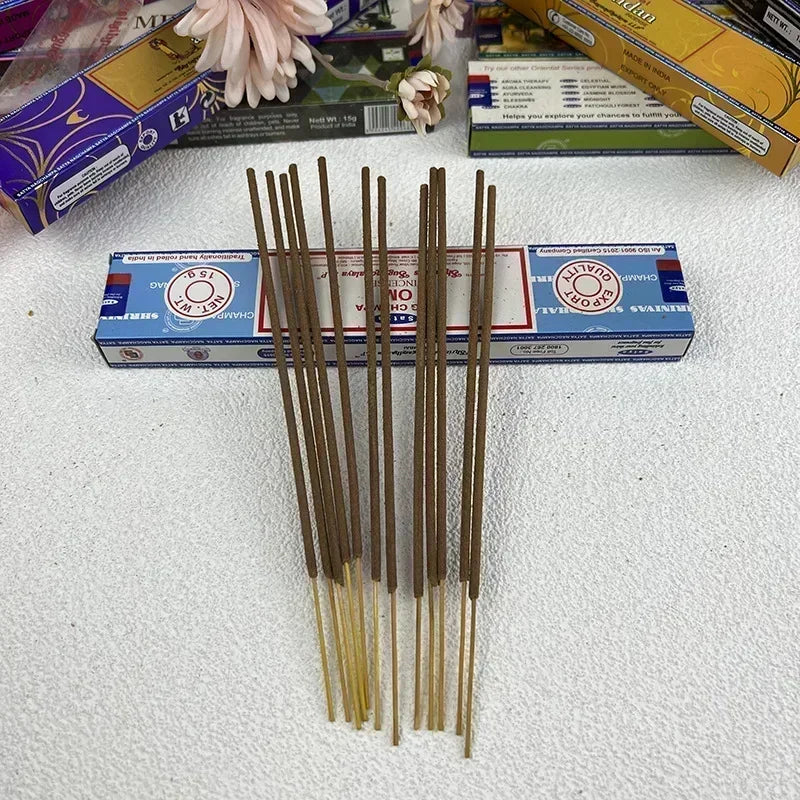 Incense sticks with a blue box on a white surface