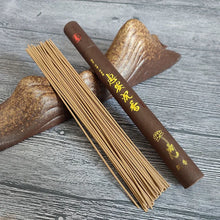 Incense sticks and an incense holder on a textured surface