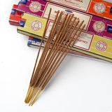 Incense sticks in front of colorful boxes on a white background