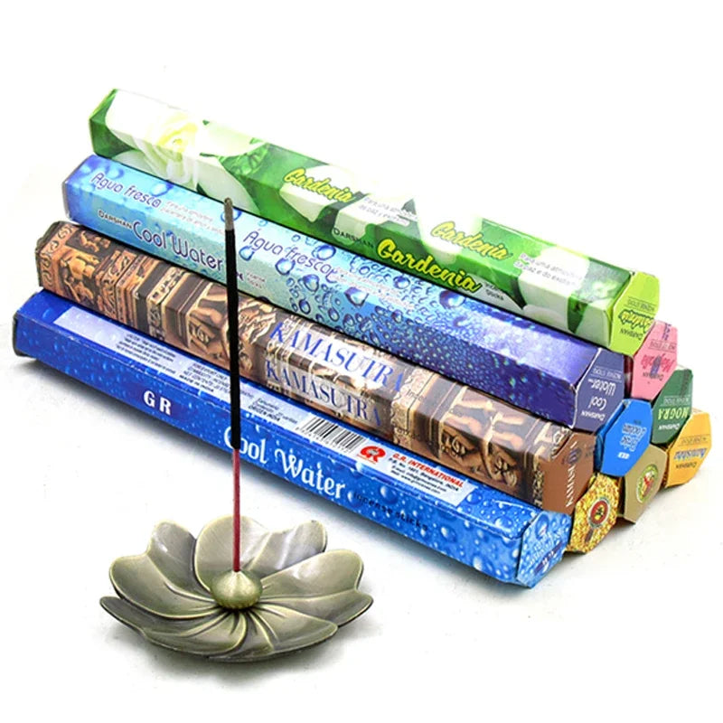 Incense sticks with colorful packaging and a ceramic incense holder on a white background