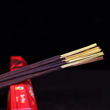 Incense sticks with red packaging on a black background