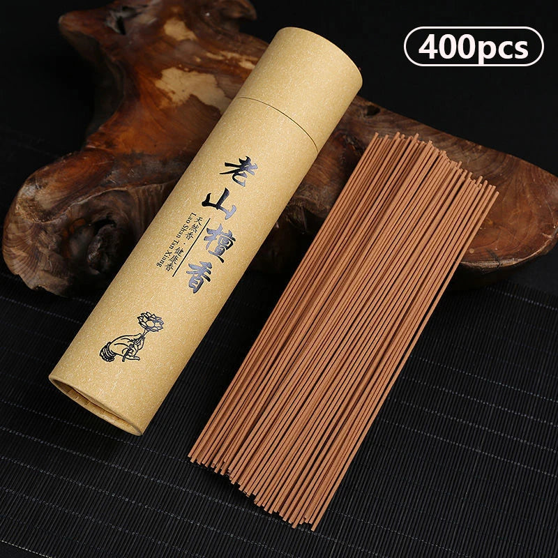 Kraft paper tube with incense sticks on a dark surface