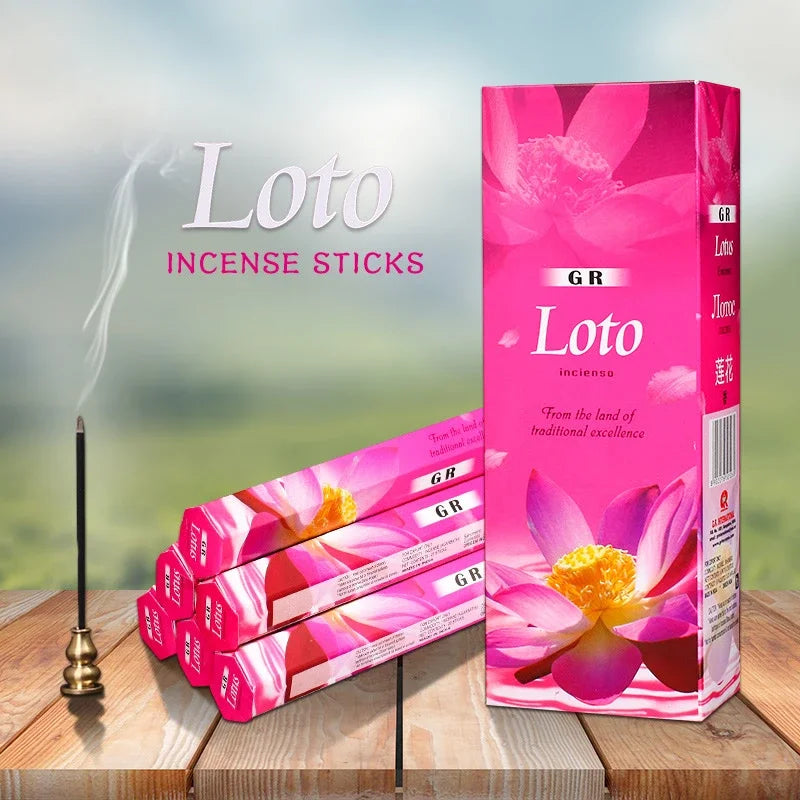 Loto incense sticks with packaging on a wooden surface and blurred natural background