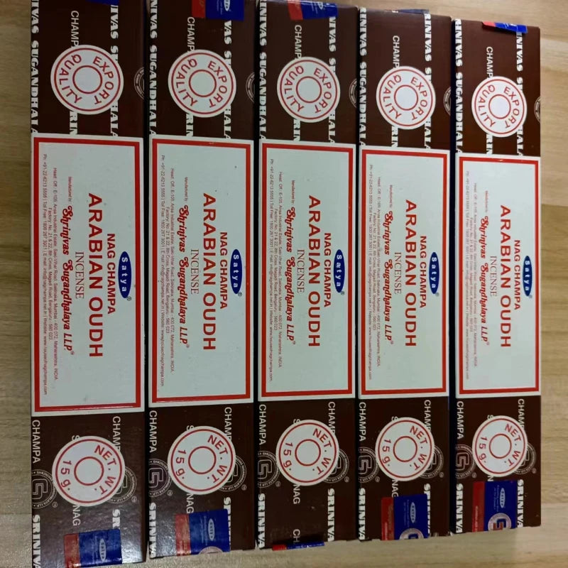 Multiple boxes of Arabian Oudh incense on a wooden surface