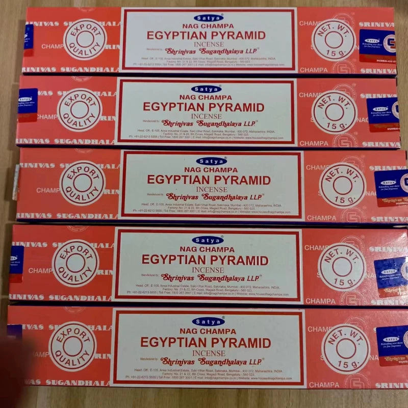 Multiple boxes of Nag Champa Egyptian Pyramid incense on a wooden surface