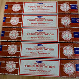 Multiple boxes of Satya Nag Champa Yogic Meditation incense on a wooden surface