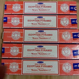 Multiple boxes of Nag Champa Egyptian Pyramid incense on a wooden surface