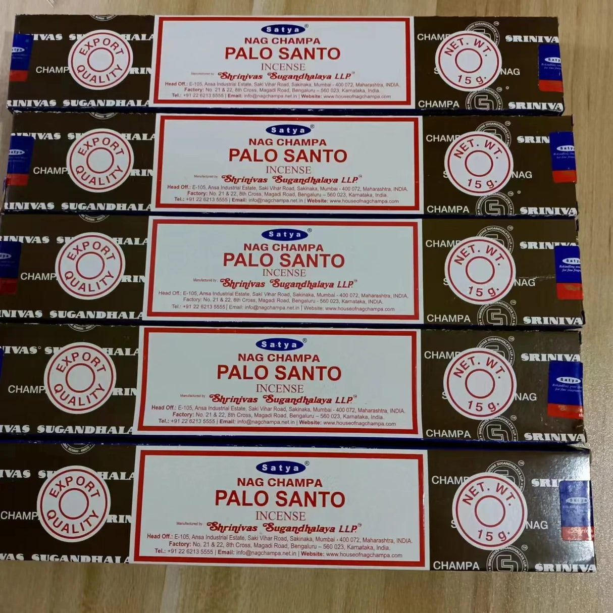 Multiple boxes of Nag Champa Palo Santo incense on a wooden surface