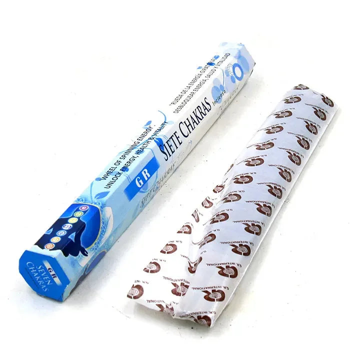 Roll of paper with printed design next to its packaging on a white background