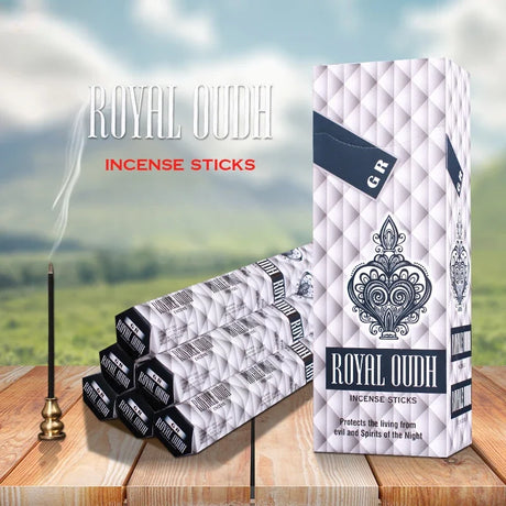 Royal Oudh incense sticks packaging with incense sticks and holder on a wooden surface.