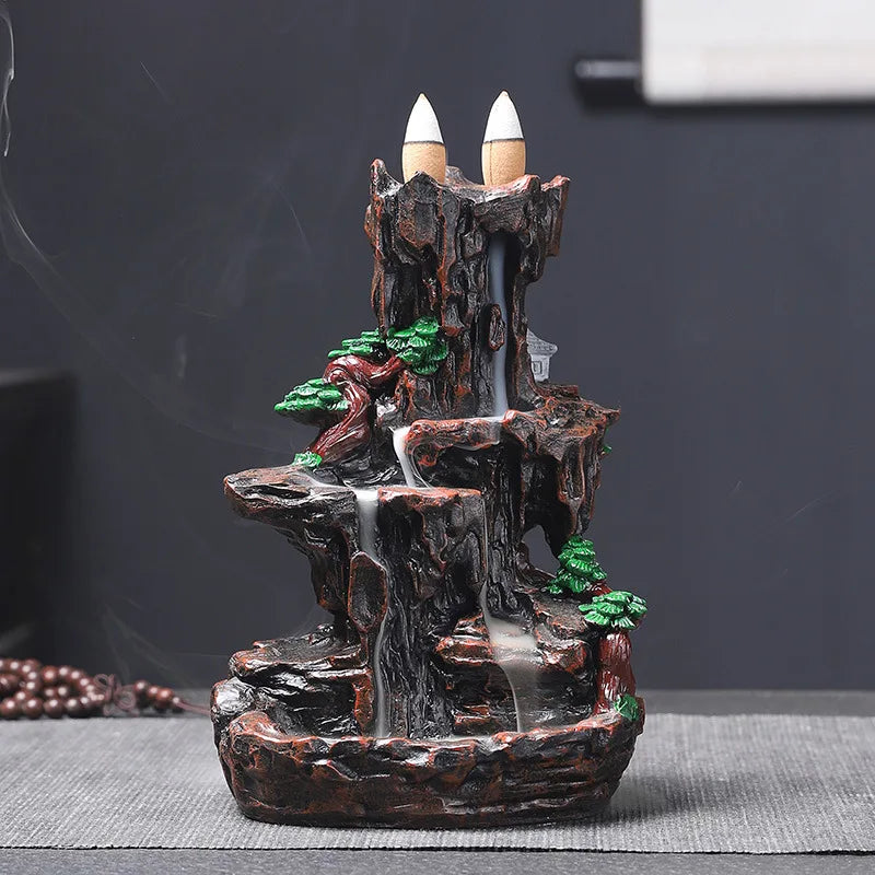 Decorative mountain fountain with candles on a dark background