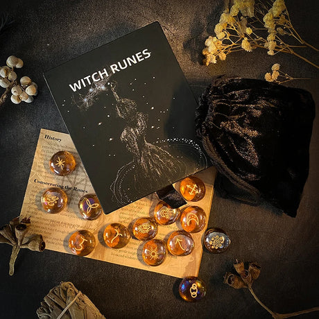 Witch Runes set with runes on a wooden board, surrounded by dried flowers and a black bag.