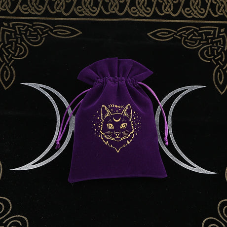 Purple drawstring bag with a cat design on a black background with moon symbols