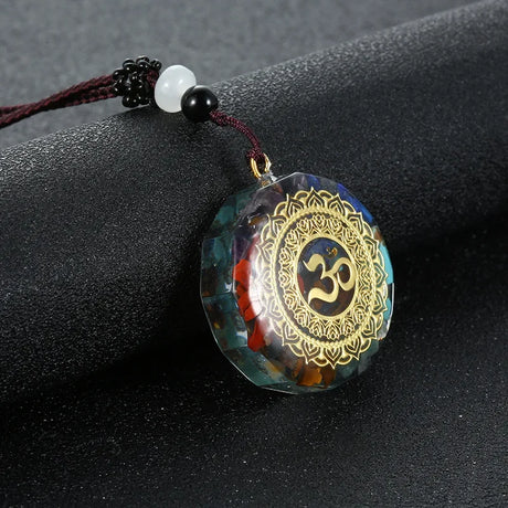 Decorative pendant with Om symbol on a dark surface