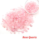 Rose Quartz stones with a bowl of stones on a white background.