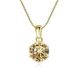 Gold pendant with a large gemstone on a white background