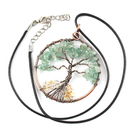 Necklace with a tree-shaped pendant featuring green stones on a white background
