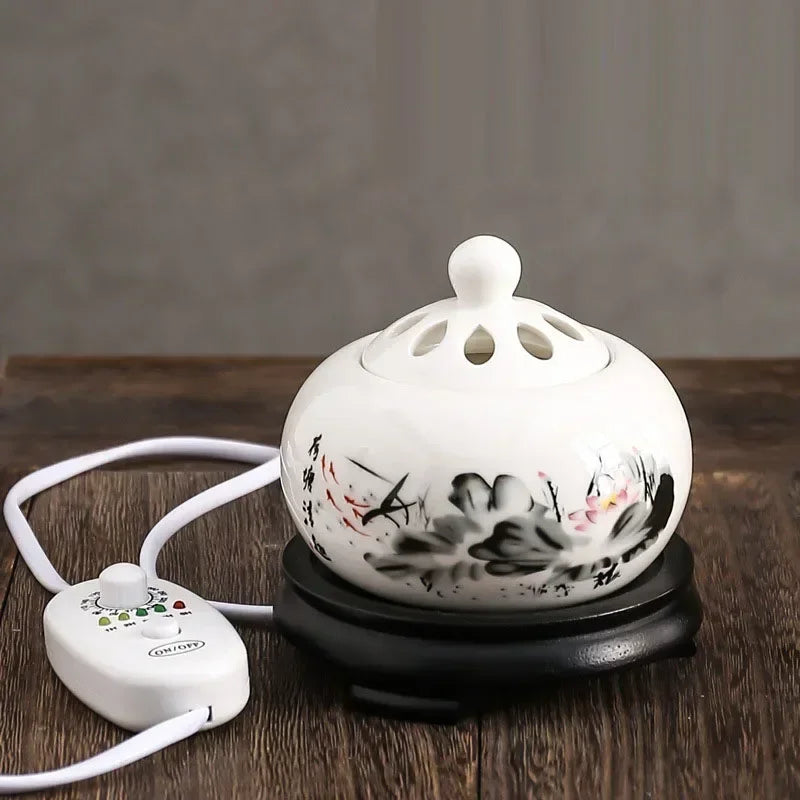 Ceramic oil burner with floral design on a wooden surface