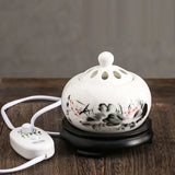 Ceramic oil burner with floral design on a wooden surface