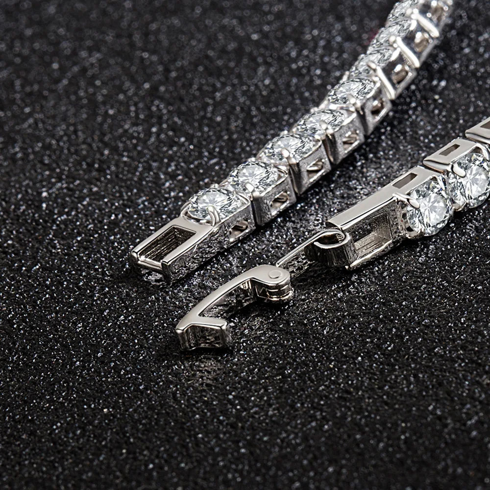 Close-up of a silver bracelet with clear stones on a dark textured background