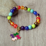 Colorful beaded bracelet with a puzzle piece charm on a wooden surface