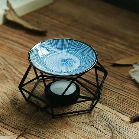 Decorative candle holder with blue glass dish on a wooden surface
