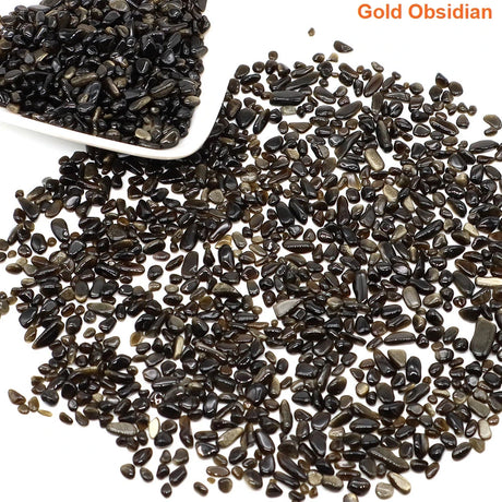 Gold Obsidian stones with a white scoop on a white background