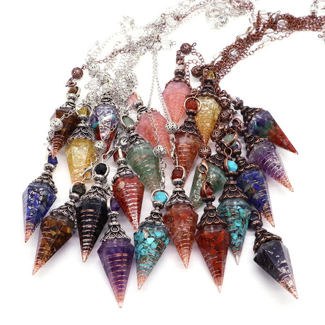 Colorful crystal pendulums on a white background