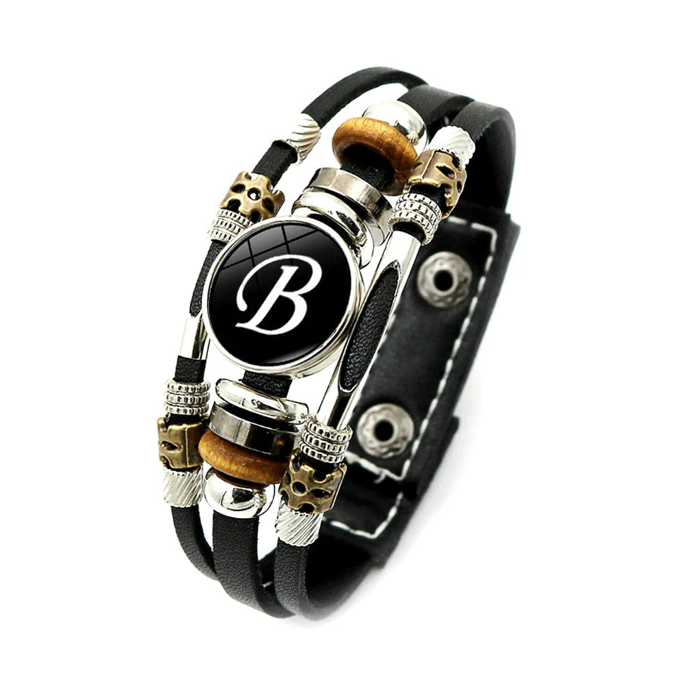 Multistrand bracelet with black leather strap and decorative beads on a white background