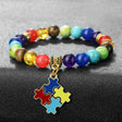 Colorful beaded bracelet with a puzzle piece charm on a gray background
