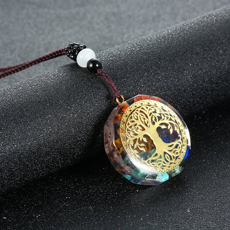 Decorative pendant with tree of life design on a dark surface