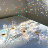 Collection of jewelry including earrings and necklaces on a reflective surface with rainbow折射效果