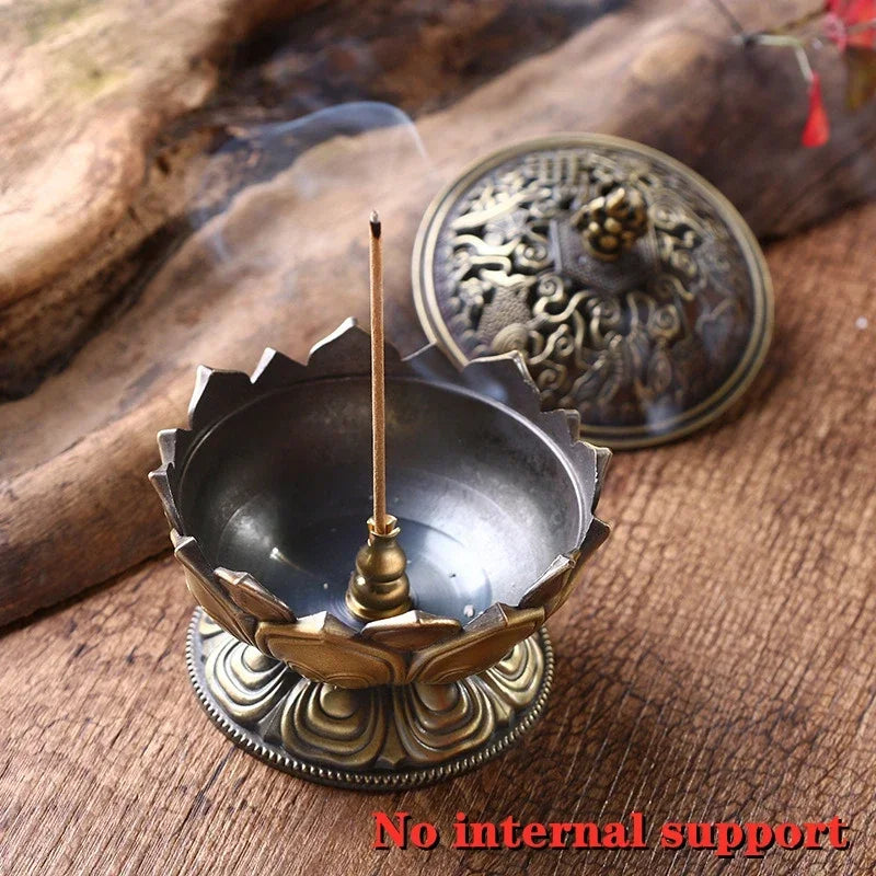 Decorative incense burner with a lit incense stick on a wooden surface