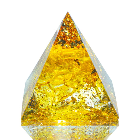 Pyramid-shaped amber crystal on a white background