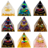 Collection of colorful pyramid-shaped orgone energy generators on a white background