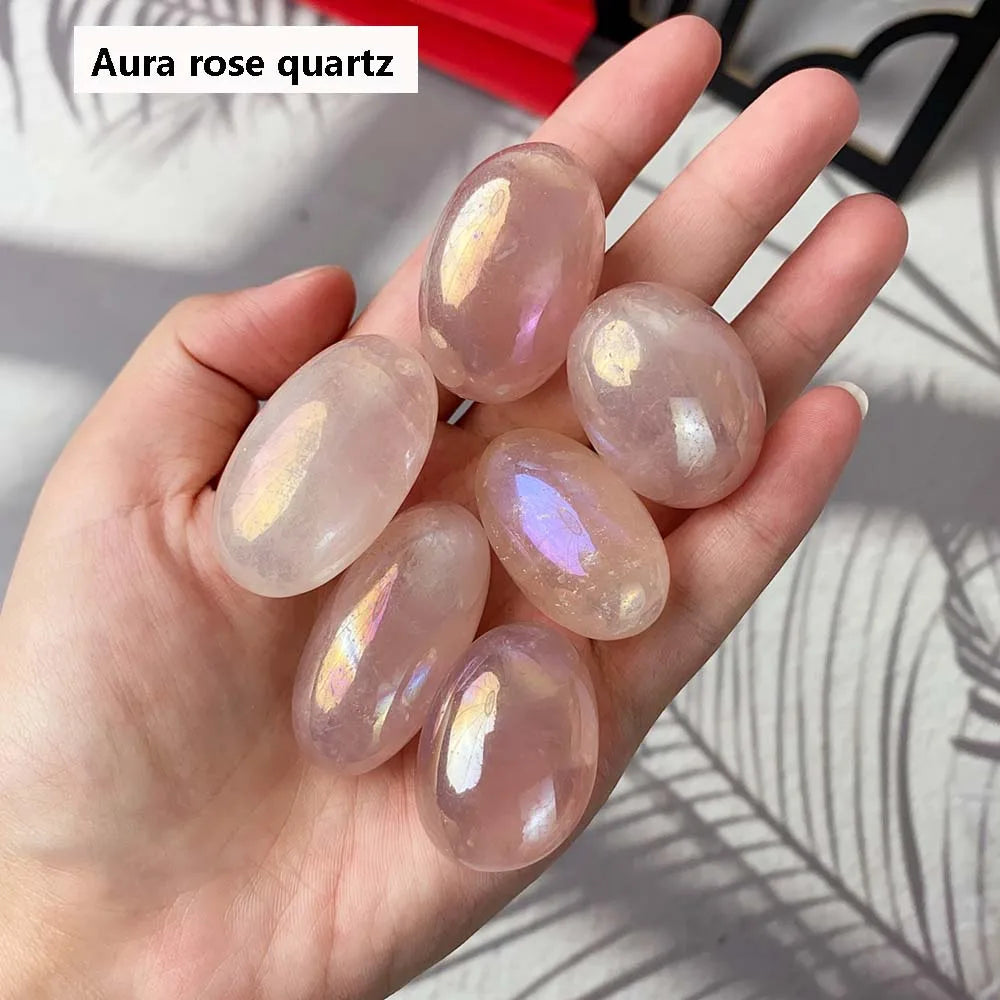 Hand holding rose quartz stones with 'Aura rose quartz' text above
