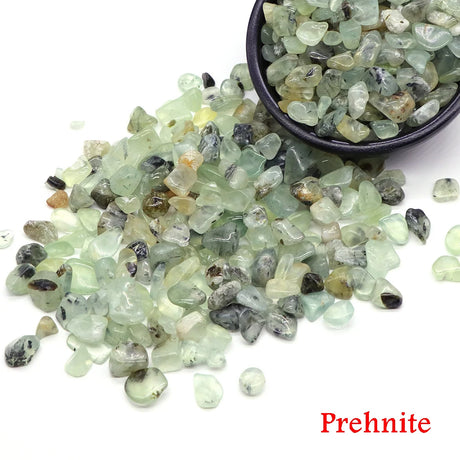 Prehnite stones with a bowl on a white background
