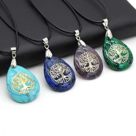 Four tree-of-life pendants in turquoise, blue, purple, and green on a white background.