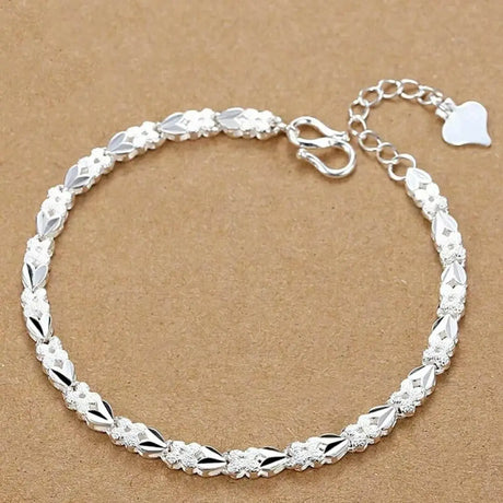 Silver bracelet on a brown background