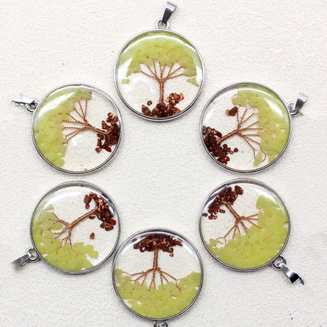 Six circular pendants with tree designs on a white background